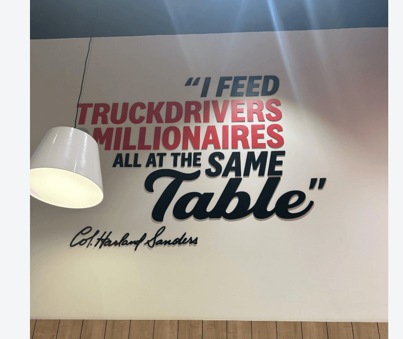 Wall quote reading I feed truck drivers millionaires all at the same table by Col. Harland Sanders