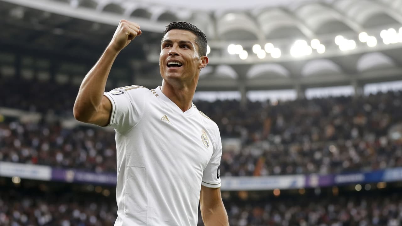 Illustrative scene of a footballer in white celebrating in a packed stadium