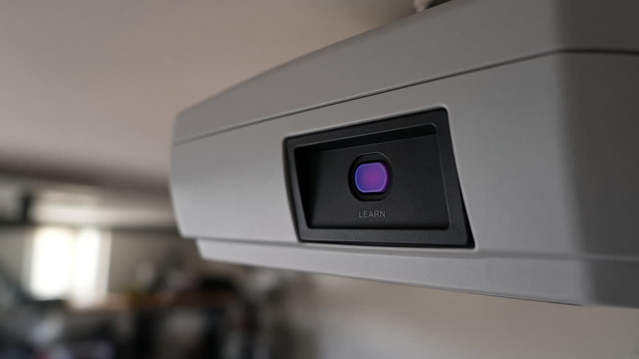 Close-up of colored learn button on a garage motor unit