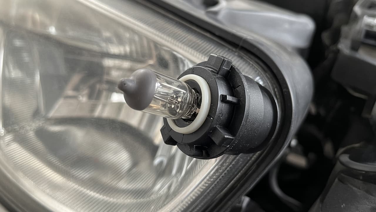 Locating tabs on a headlight bulb base noted before removal